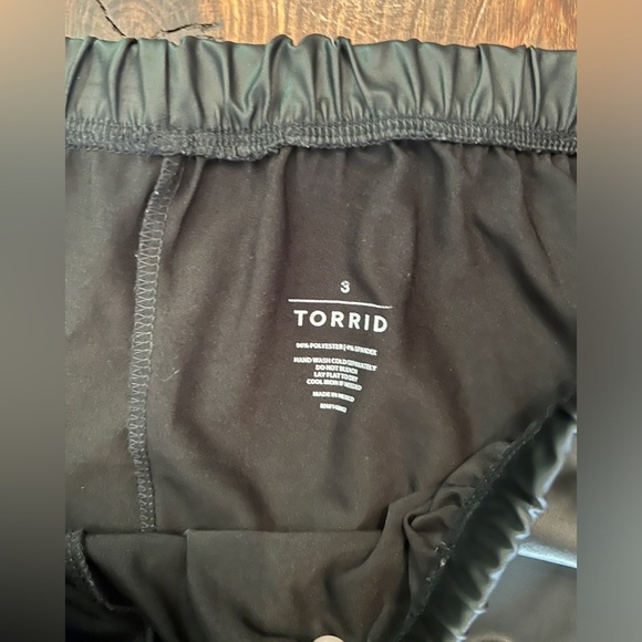 TORRID Faux Leather Black Cropped Leggings Bow Accents On Back - Picture 4 of 10